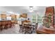 Well-lit kitchen with dining area features light wood cabinets and ample counter space at 15345 Angus Rd, Polk City, FL 33868