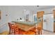 Kitchen bar with wooden stools and cabinets at 15345 Angus Rd, Polk City, FL 33868