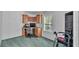 Home office with carpet, a built-in desk, shelving, and a window at 15345 Angus Rd, Polk City, FL 33868