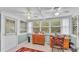 Sunroom with ceiling fans, windows, and red patterned rug at 15345 Angus Rd, Polk City, FL 33868