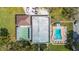 Aerial view showcasing the community pool, bocce court, clubhouse, and surrounding greenery at 1610 Reynolds Rd # 214, Lakeland, FL 33801