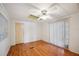 Bright bedroom featuring wood floors, ceiling fan and natural light from windows at 1610 Reynolds Rd # 214, Lakeland, FL 33801
