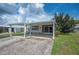 Charming home exterior featuring a covered carport and well-maintained lawn at 1610 Reynolds Rd # 214, Lakeland, FL 33801