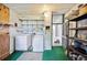 Functional laundry room includes washer, dryer, and storage shelves for convenience at 1610 Reynolds Rd # 214, Lakeland, FL 33801