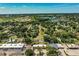 Scenic aerial view of a neighborhood with mature trees, sidewalks, and nearby commercial district perfect for convenience at 1720 Park Dr, Lakeland, FL 33803