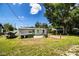 This expansive backyard has a well-maintained lawn, utility sink, and red-paved patio, ideal for outdoor enjoyment at 1720 Park Dr, Lakeland, FL 33803