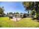 Spacious backyard featuring a red-paved patio, grassy lawn, and a well-maintained home exterior at 1720 Park Dr, Lakeland, FL 33803