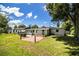 A spacious backyard features a red-paved patio, green lawn, and a well-maintained home exterior at 1720 Park Dr, Lakeland, FL 33803