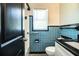 Retro blue and white bathroom featuring contrasting black and white tiled flooring at 1720 Park Dr, Lakeland, FL 33803