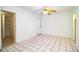 Spacious bedroom features tile flooring, ceiling fan and closet storage at 1720 Park Dr, Lakeland, FL 33803