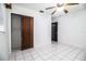 Bedroom with tile floors and a closet with wood doors at 1720 Park Dr, Lakeland, FL 33803
