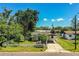 Charming single-story home featuring a covered carport and white picket fence at 1720 Park Dr, Lakeland, FL 33803