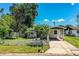 Charming single-story home featuring a covered carport and white picket fence at 1720 Park Dr, Lakeland, FL 33803