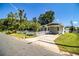 Charming single-story home with a well-kept lawn, a carport, and a white picket fence at 1720 Park Dr, Lakeland, FL 33803