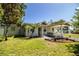 Inviting single-story home featuring a carport, well-manicured lawn, and a charming white picket fence at 1720 Park Dr, Lakeland, FL 33803