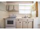 Traditional kitchen features tile countertop, white cabinets, oven, and tiled walls at 1720 Park Dr, Lakeland, FL 33803