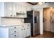 Cozy kitchen with tiled countertop, white cabinetry, and stainless steel refrigerator at 1720 Park Dr, Lakeland, FL 33803