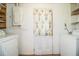 Functional laundry area with washer and dryer hookups and floral curtain over door at 1720 Park Dr, Lakeland, FL 33803