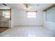 Open living area features bright white tile flooring, fresh paint, and natural light at 1720 Park Dr, Lakeland, FL 33803