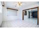 Bright living room features tile floors, large windows, and a decorative ceiling fan at 1720 Park Dr, Lakeland, FL 33803
