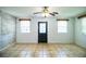 View of the bright living room featuring fresh paint, tile floor, and two large windows at 1720 Park Dr, Lakeland, FL 33803