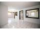 Open living area features bright white tile flooring, fresh paint, and natural light at 1720 Park Dr, Lakeland, FL 33803