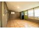Neutral room featuring a refrigerator and a view through the exterior door and window at 1720 Park Dr, Lakeland, FL 33803