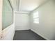 Room featuring gray painted flooring, window, and natural lighting at 1720 Park Dr, Lakeland, FL 33803
