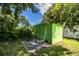 Outdoor storage shed surrounded by lush greenery, providing practical storage solutions at 1720 Park Dr, Lakeland, FL 33803