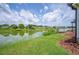 Lush green backyard extending to a serene lake, perfect for enjoying nature and outdoor activities at 2055 S Floral Ave # 245, Bartow, FL 33830
