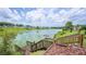 Picturesque backyard with wooden steps leading to the lake, ideal for nature lovers at 2055 S Floral Ave # 245, Bartow, FL 33830