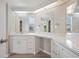 Bathroom featuring double sinks, white cabinets, light countertops and modern fixtures at 2055 S Floral Ave # 245, Bartow, FL 33830