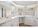 Bathroom featuring double sinks, white cabinets, light countertops and modern fixtures at 2055 S Floral Ave # 245, Bartow, FL 33830