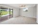 Spacious bedroom with neutral carpet, sliding glass doors to patio and serene views at 2055 S Floral Ave # 245, Bartow, FL 33830
