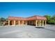 Charming community building featuring a beautiful terracotta tiled roof, arched walkways and inviting benches at 2055 S Floral Ave # 245, Bartow, FL 33830