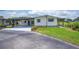 Exterior of home featuring a covered carport and well-manicured lawn, providing a welcoming entrance at 2055 S Floral Ave # 245, Bartow, FL 33830