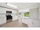 Modern kitchen with stainless steel appliances, white cabinets, light countertops, and wood-look flooring at 2055 S Floral Ave # 245, Bartow, FL 33830