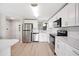 Modern kitchen featuring stainless steel appliances, white cabinets, and a stylish design at 2055 S Floral Ave # 245, Bartow, FL 33830