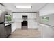 Renovated kitchen featuring stainless appliances, subway tile backsplash, and modern cabinets at 2055 S Floral Ave # 245, Bartow, FL 33830