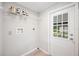 Functional laundry room with storage shelf and window view of the backyard at 2055 S Floral Ave # 245, Bartow, FL 33830