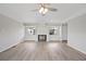 Cozy living room with fireplace, ceiling fan, neutral color palette, and wood-look floors at 2055 S Floral Ave # 245, Bartow, FL 33830