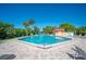 Beautiful community pool with ample seating, clear blue water, and tropical landscaping for serene relaxation at 2055 S Floral Ave # 245, Bartow, FL 33830