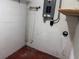 This basement corner shows white painted brick, utilities, and painted concrete floors at 2105 E Cherokee St, Bartow, FL 33830