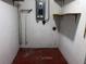 This unfinished basement features concrete walls and floors, exposed pipes, and an electrical panel at 2105 E Cherokee St, Bartow, FL 33830