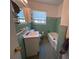 Bathroom with blue tile, classic fixtures and window at 2105 E Cherokee St, Bartow, FL 33830