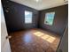 This bedroom features two windows, patterned flooring, and space-themed decorations at 2105 E Cherokee St, Bartow, FL 33830