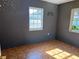 This bedroom features two windows, patterned flooring, and space-themed decorations at 2105 E Cherokee St, Bartow, FL 33830