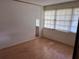 Bedroom featuring faux wood flooring, white walls, and a large window at 2105 E Cherokee St, Bartow, FL 33830