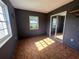 This bedroom features two windows, patterned flooring, and a mirrored closet at 2105 E Cherokee St, Bartow, FL 33830