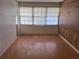 Bonus room showing faux wood flooring, wood paneling, and a bright window at 2105 E Cherokee St, Bartow, FL 33830